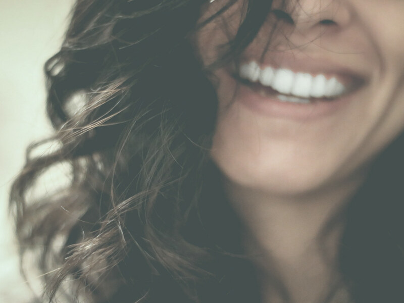 Patient admiring her teeth in a mirror