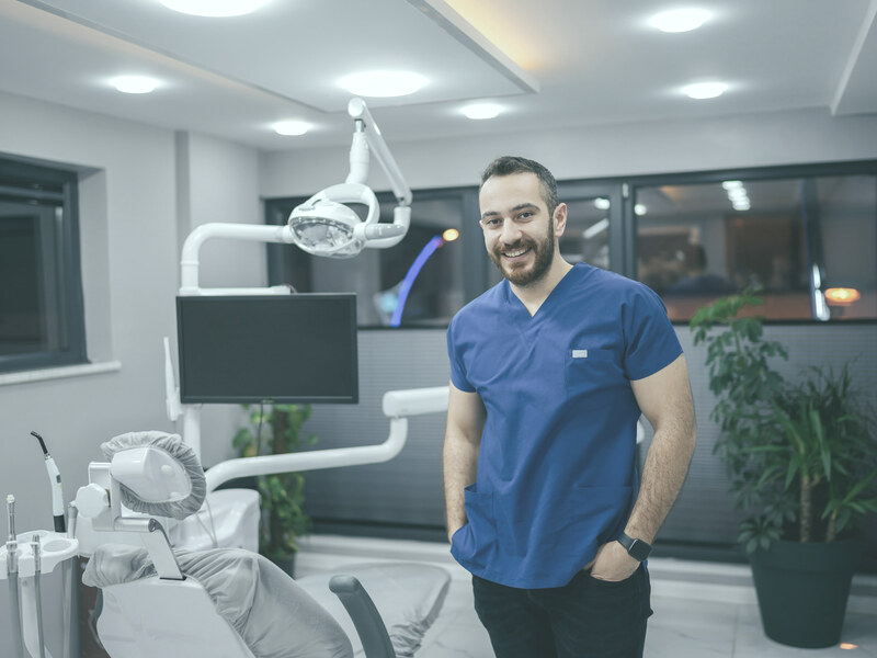 Dentist treating a child patient with an assistant