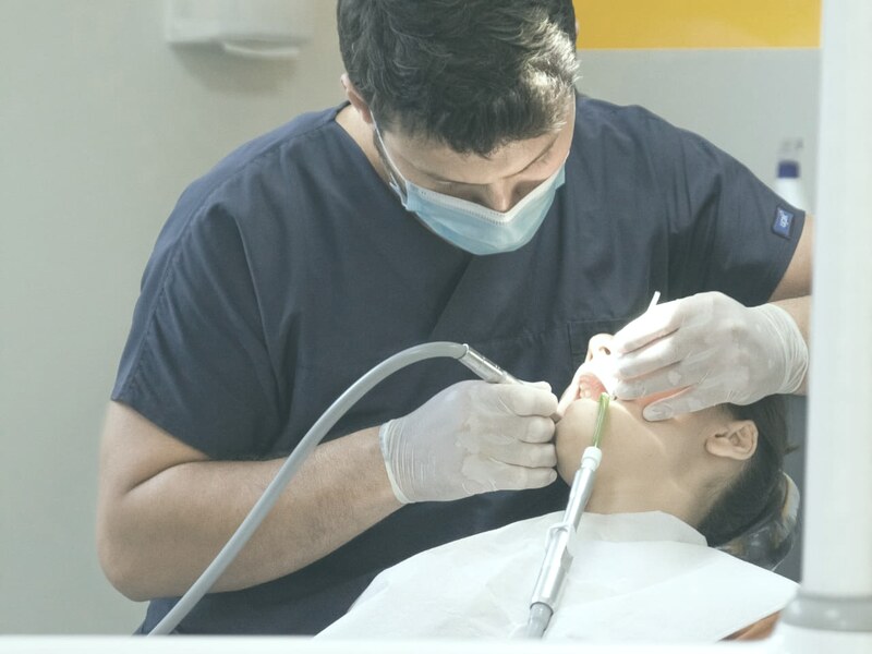 Patient smiling as a dentist explains a dental model