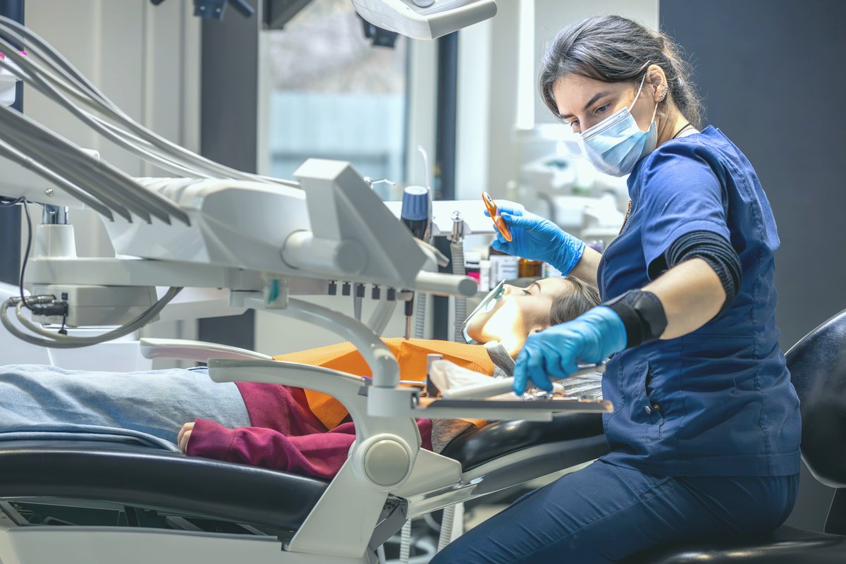 Young dentist standing in a bright modern dental office