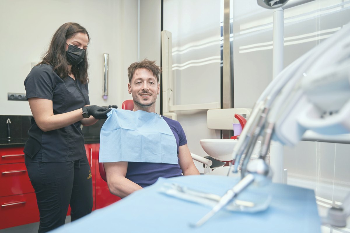 Dental professional preparing a patient for examination