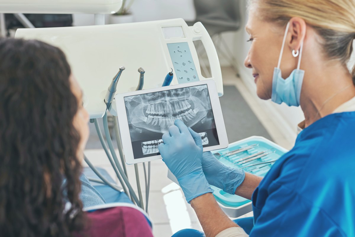 Dentist reviewing an X-ray with a patient